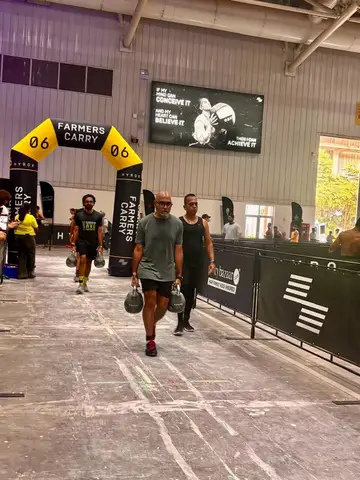 Kettlebells carried down the lane of a Hyrox race