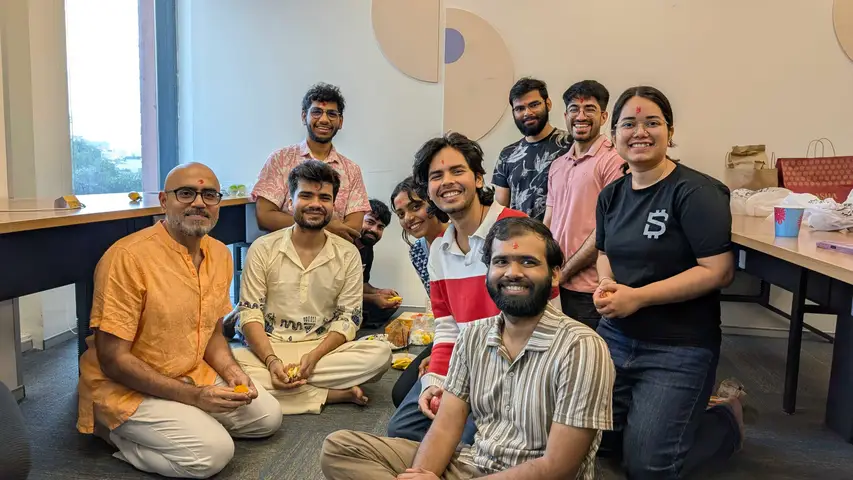 A puja on the office floor, everyone sitting together