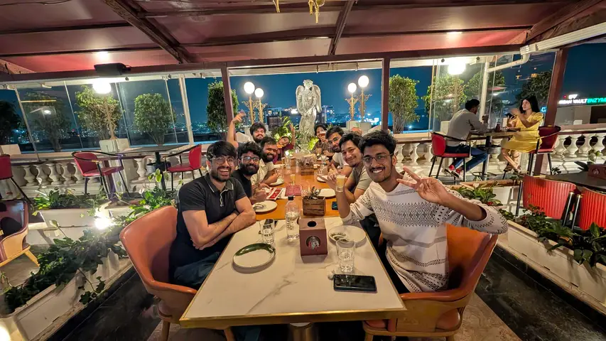 The whole table at a rooftop dinner